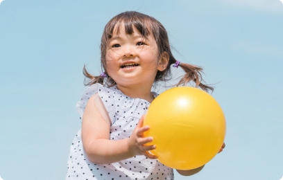 黄色いボールを持って遊ぶ女の子