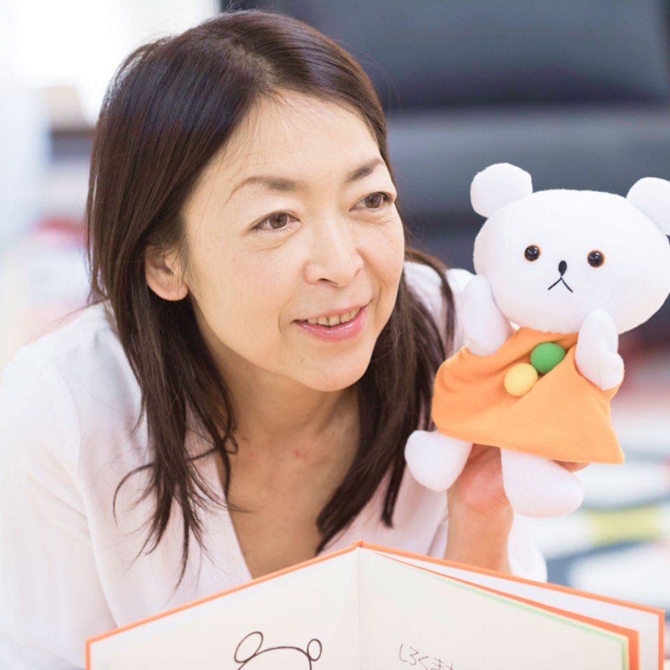 白いクマの人形を持って読み聞かせをする女性